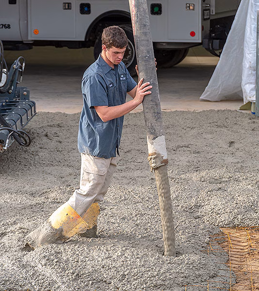 A worker pumps concrete at a job site in northeast Indiana